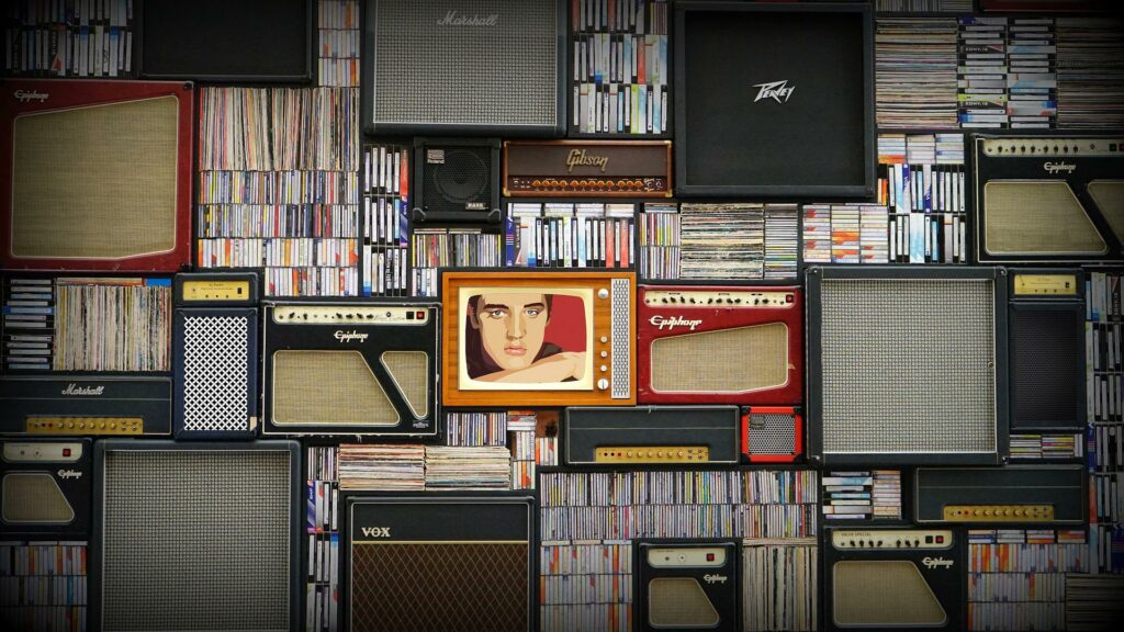TVs and retro electronics with elvis presley highlighted in the middle