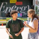 Students talk in front of a Find your Energy banner